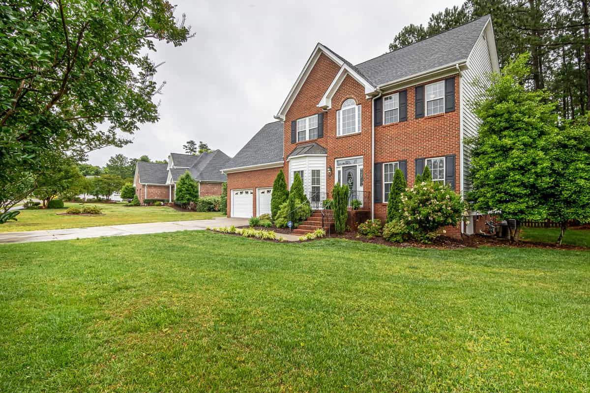 Two-story brick suburban home of the kind common across North Dallas neighborhoods
